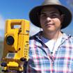 Archaeology student with surveying equipment