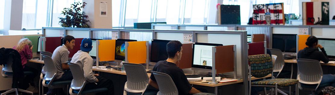 Students work in a Pima computer commons in a Pima library